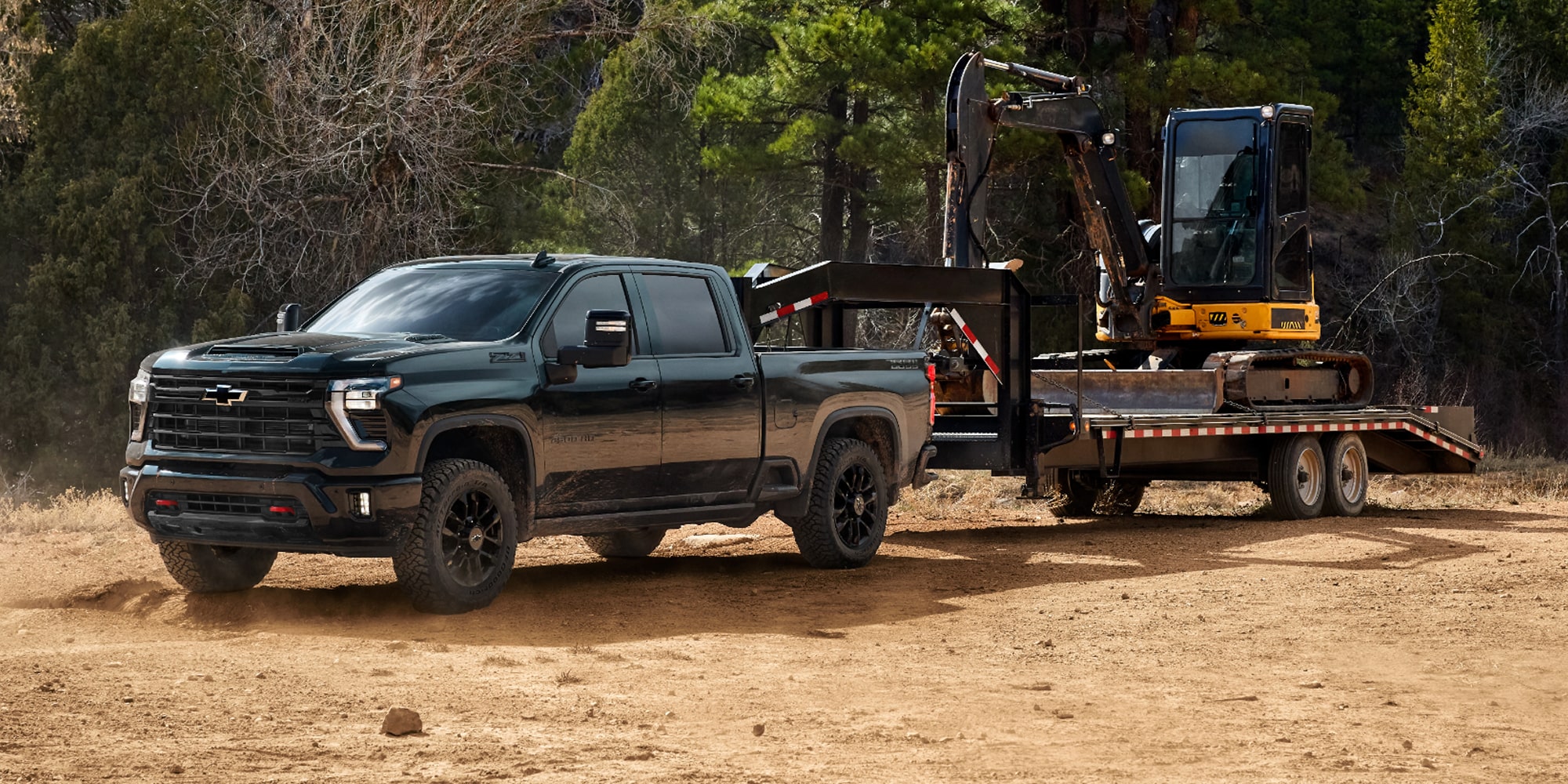 View of the 2026 Chevy Silverado with Trail Boss Trim Towing a Bulldozer