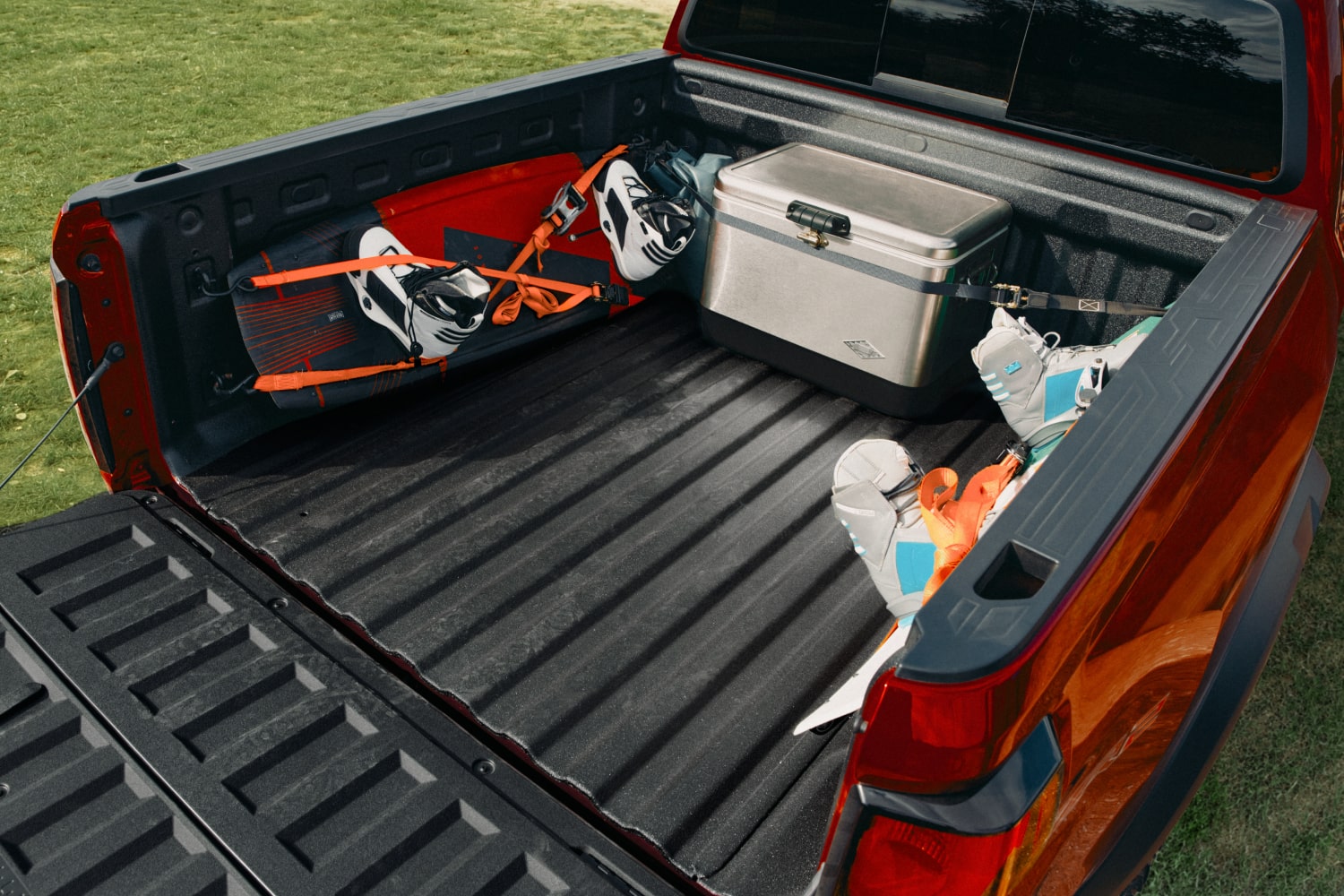 Bed of a Chevy Colorado Loaded With Outdoor Equipment, a Cooler, and Adventure Gear.