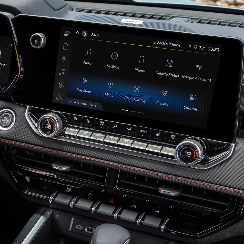Interior of a Chevy Colorado Showing the Steering Wheel, Infotainment Touchscreen, Dashboard Controls, and Center Console.