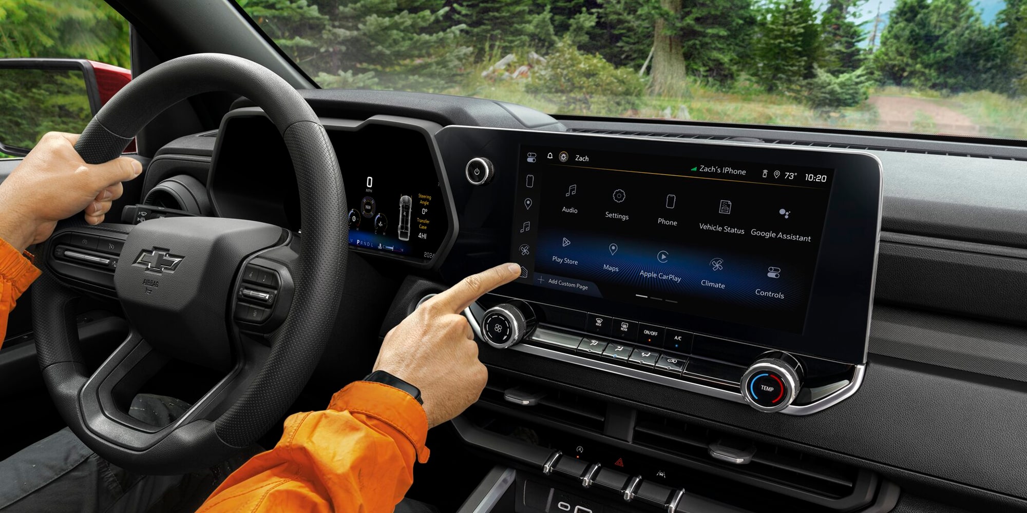 A Driver Operating the Infotainment Touchscreen and Steering Wheel Inside a Chevy Colorado.