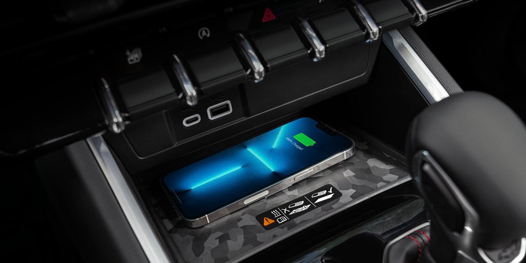 A Close-Up View of the Chevy Colorado Center Console Storage Area With a Smartphone Connected for Charging.
