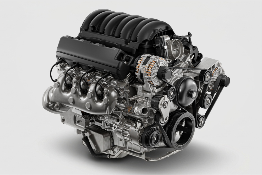 A Chevy Silverado HD Engine Shown at an Angle on a White Background Highlighting the Engine Block, Intake System, and Mechanical Components