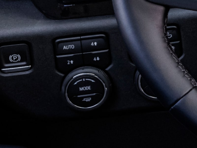 A Close-Up View of the Interior Controls in a Chevy Silverado HD Displaying the Drive Modes Selector With the Text “DRIVE MODES”