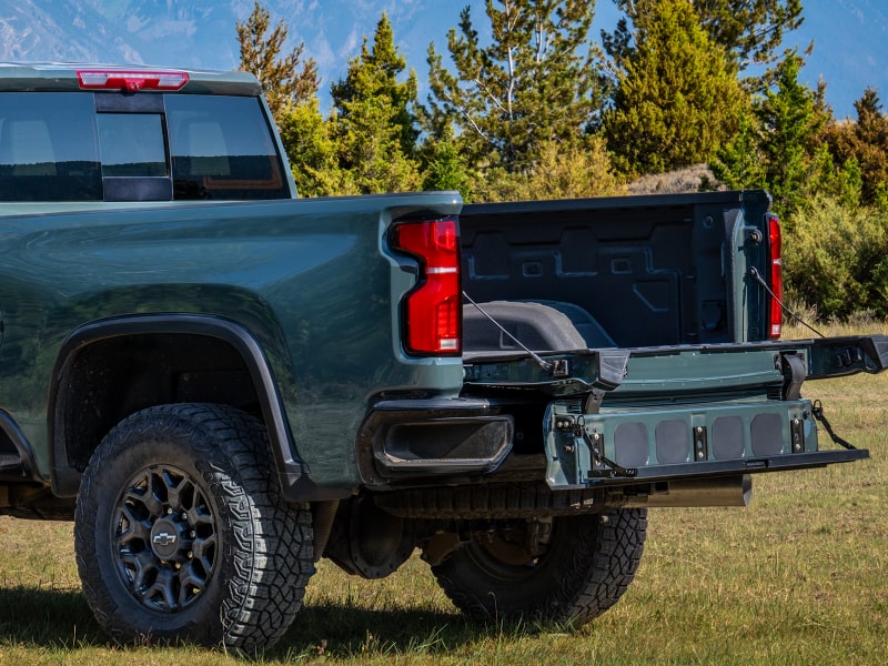 A Close-Up View of the Chevy Silverado HD Multi-Flex Tailgate Lowered Open at the Rear of the Truck With the Text “MULTI-FLEX TAILGATE”
