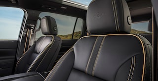 Premium Black Leather Front Seats Featuring High Country Embossed Headrests, Contrast Stitching, and a Panoramic Sunroof.