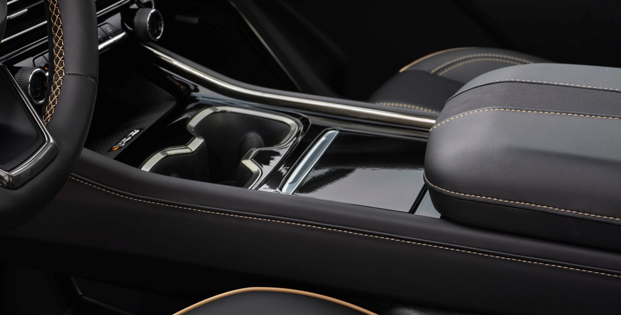 Center Console Featuring Dual Cupholders, Premium Leather Trim, and Integrated Storage Compartments.