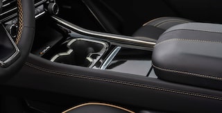 Center Console Featuring Dual Cupholders, Premium Leather Trim, and Integrated Storage Compartments.