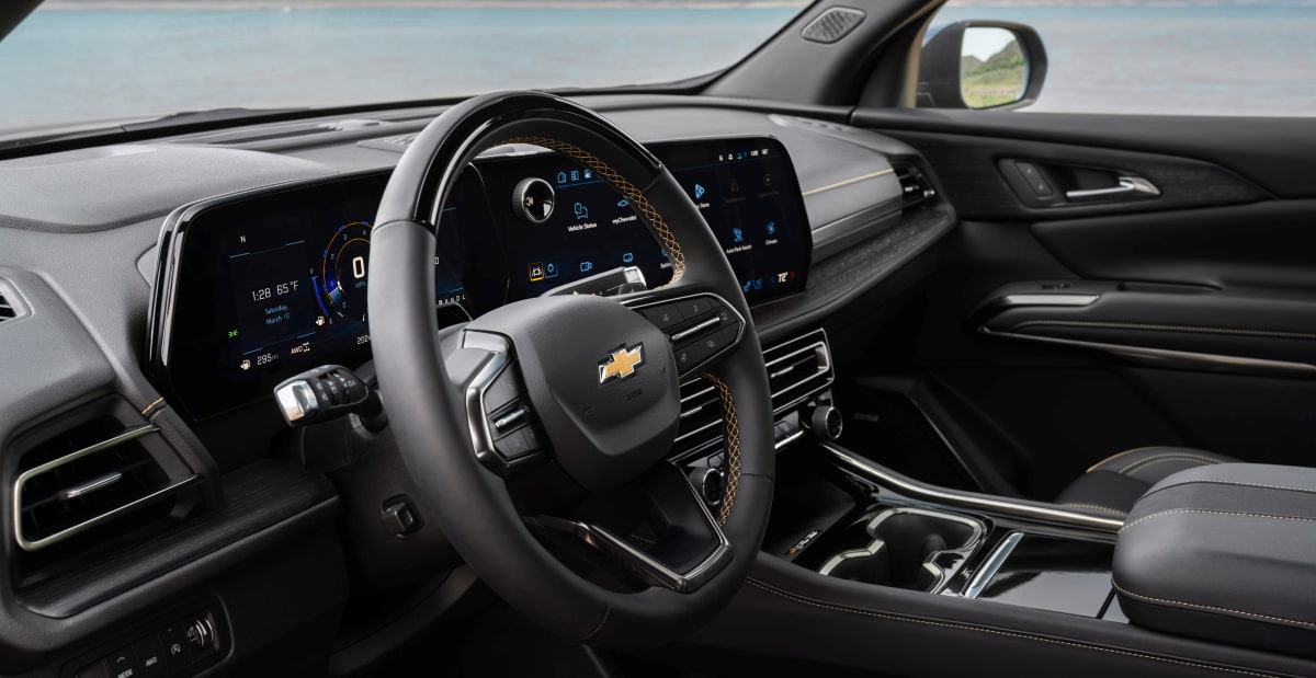 Interior View Featuring a Leather-Wrapped Steering Wheel, Digital Driver Display, and Center Touchscreen Infotainment System.