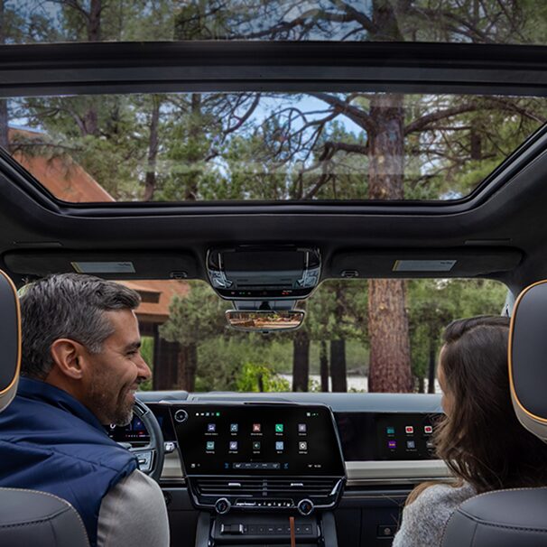 Passenger Seat View of a Man Smiling and Utilizing the Super Cruise Hands-free Technology While Driving a Chevy Silverado