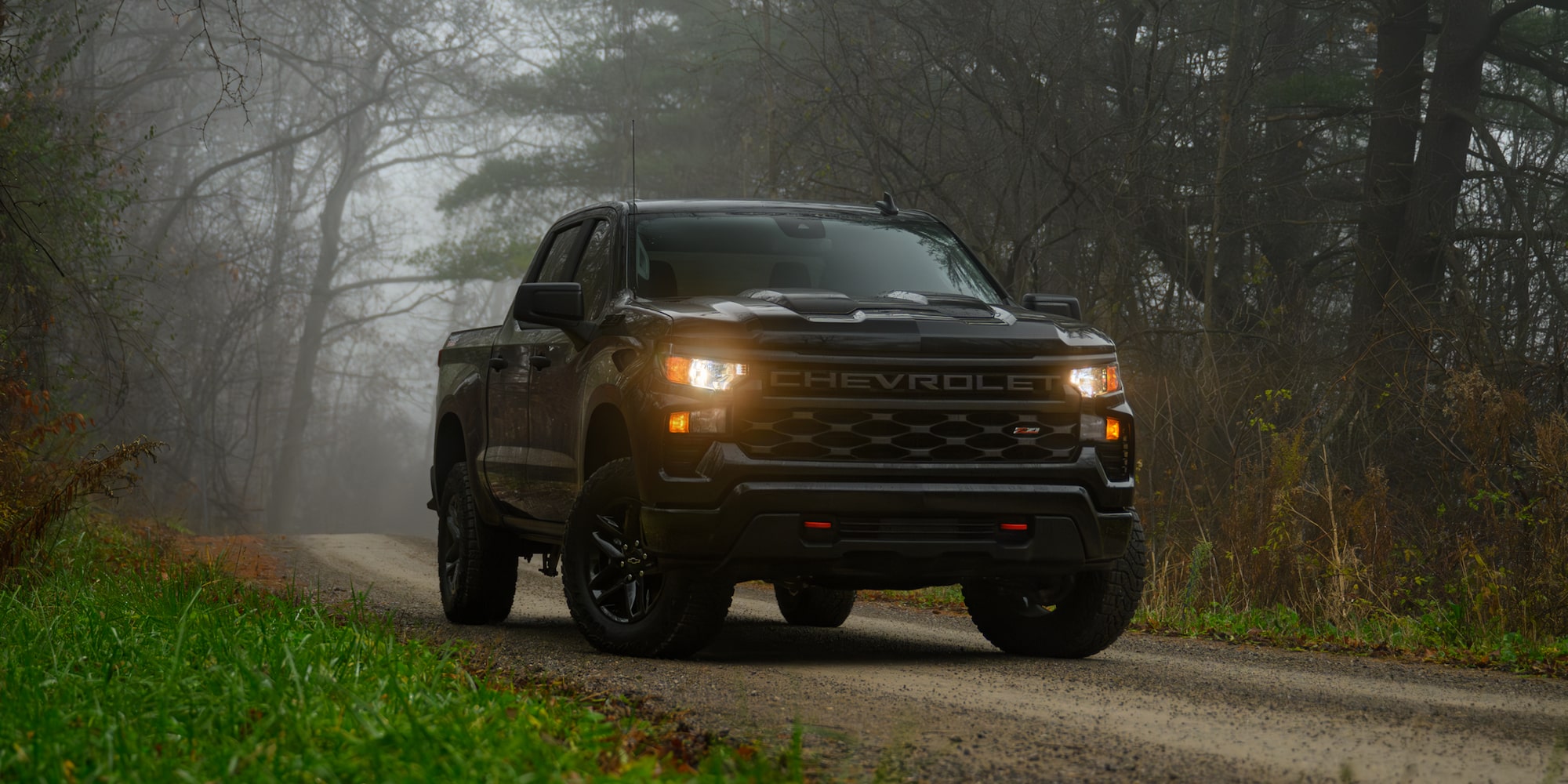 2025 Chevy Silverado LD Driving Down a Foggy Road in the Woods