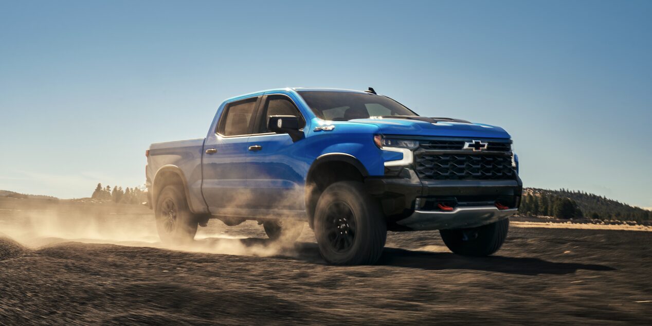 2025 Chevy Silverado LD Speeding Down a Dirt Road