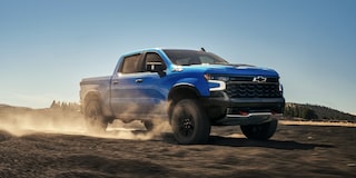 2025 Chevy Silverado LD Speeding Down a Dirt Road
