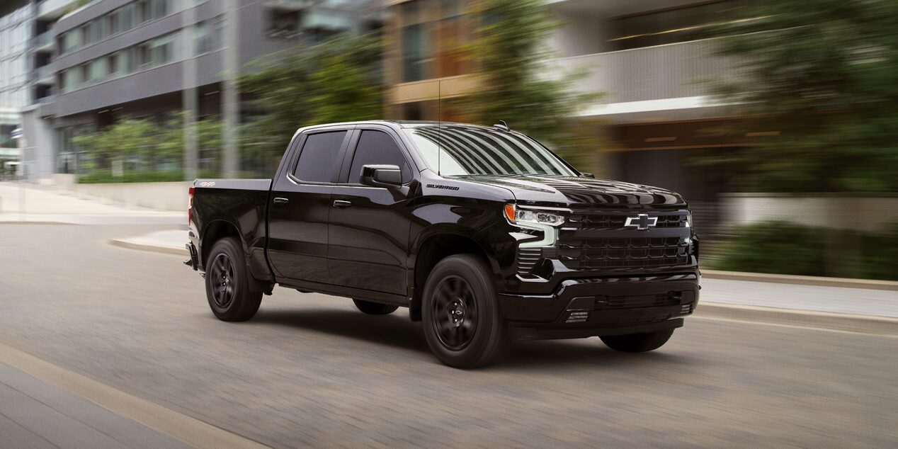 2025 Chevy Silverado LD Speeding Through a City Road
