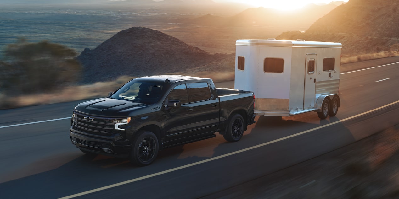 2025 Chevy Silverado LD Towing a Small Trailer on a Highway