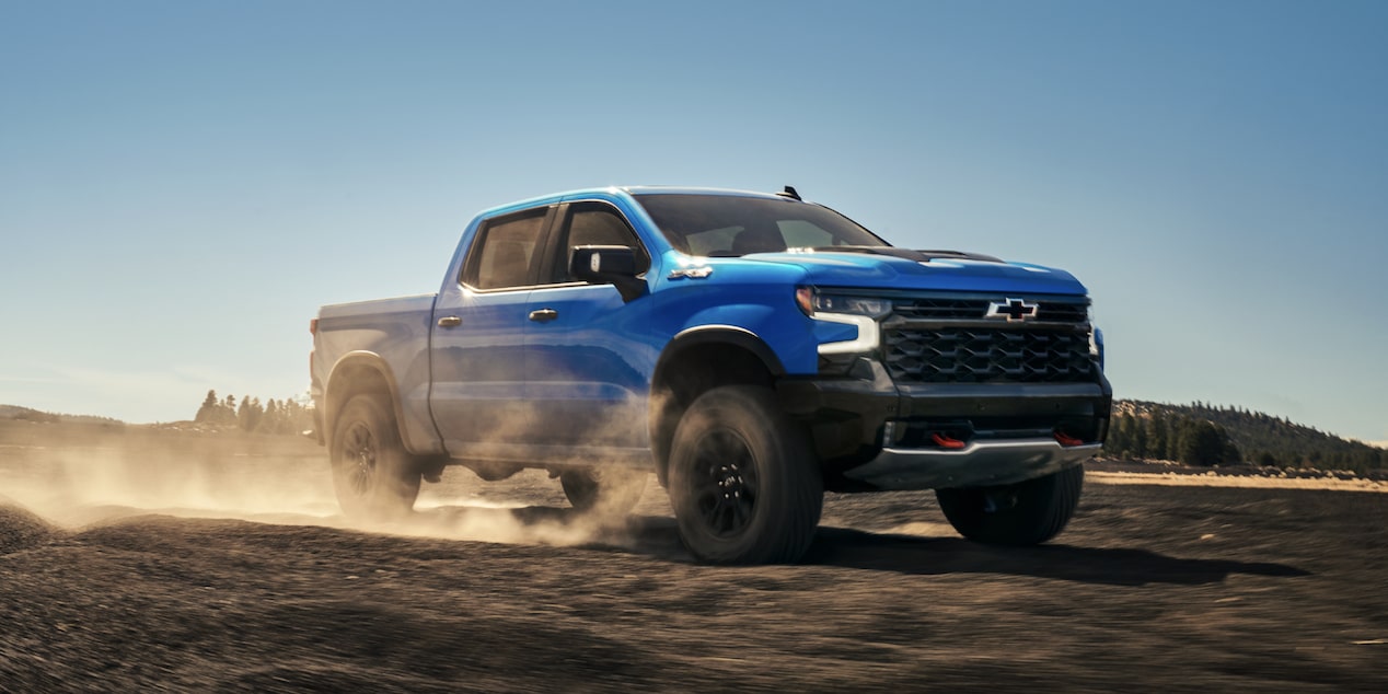 2025 Chevy Silverado LD Speeding Down a Dirt Road
