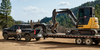 Chevy Trail Boss Truck Towing Construction Heavy Machinery in the Woods