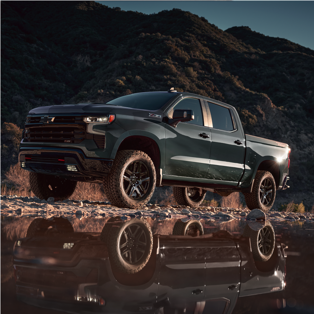 Silverado 1500 Trail Boss conduciendo por una montaña cerca de un charco