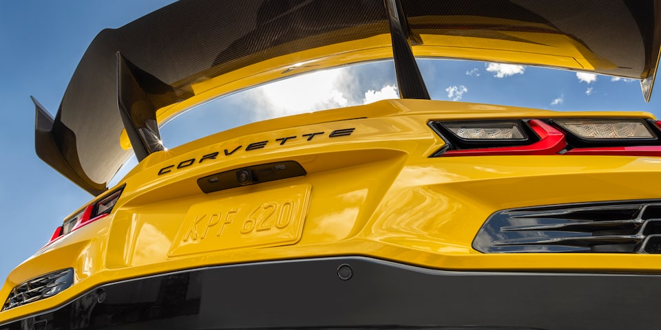 Low Angle Shot from under the Rear Tail of a Yellow Chevy Corvette ZR1 with a Blue Sky Above