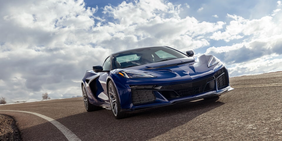 Low Angle Three Quarter View of a Blue Chevy Corvette ZR1 Going down the Road on a Sunny Day