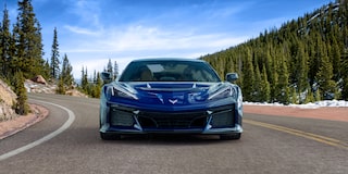 Front View of a Blue Chevy Corvette ZR1 Driving Down the Road with a Blue Sky