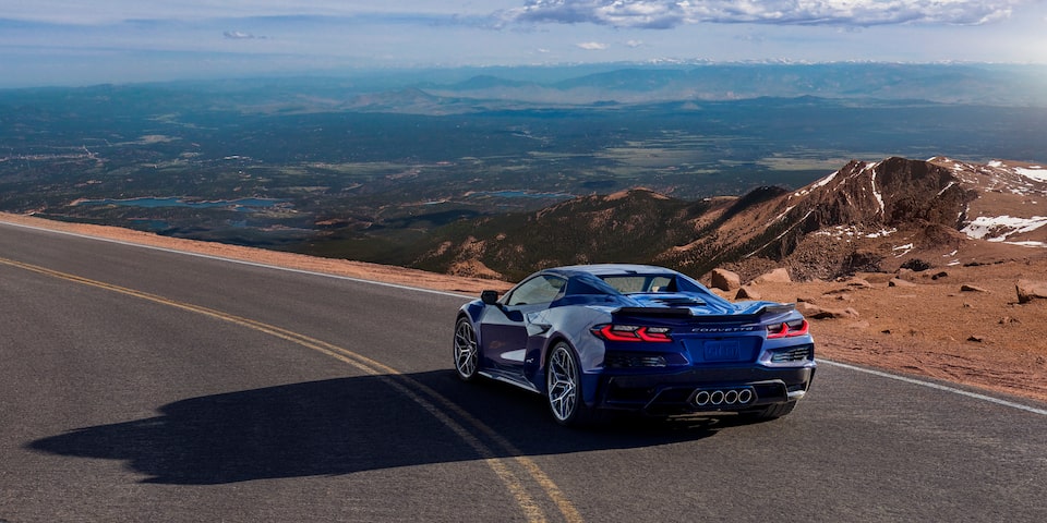 Three Quarters Rear View of a Blue Chevy Corvette ZR1 Surrounded by Mountains