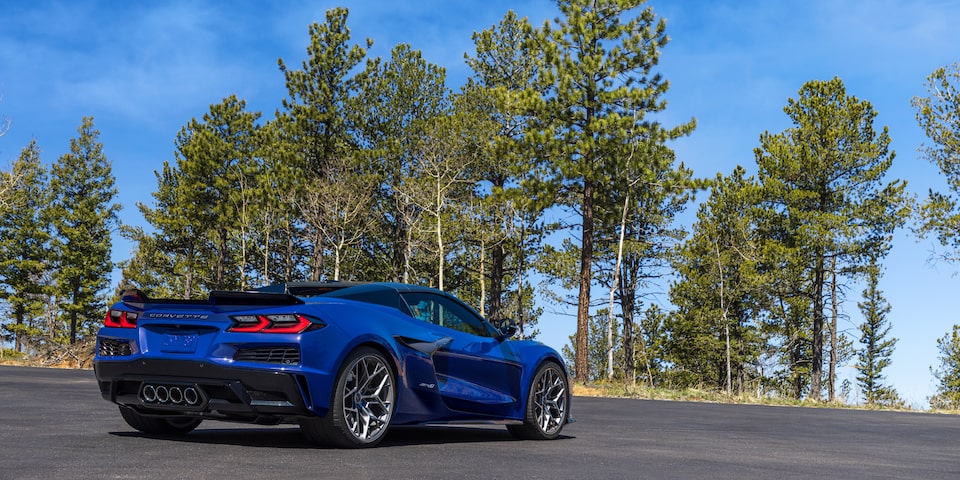 Three Quarters Rear View of a Blue Chevy Corvette ZR1 with Trees in Front