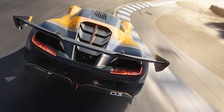 Back View of a Yellow and Black 2026 Corvette CX.R Racing on a Track