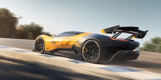 Side View of a Yellow and Black 2026 Corvette CX.R Racing on a Track