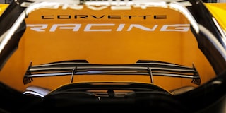 Side View of a Yellow and Black 2026 Corvette CX.R Racing on a Track