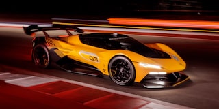 Side View of a Yellow and Black 2026 Corvette CX.R Racing on a Track