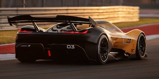 Side View of a Yellow and Black 2026 Corvette CX.R Racing on a Track