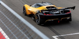 Side View of a Yellow and Black 2026 Corvette CX.R Racing on a Track
