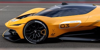 Side View of a Yellow and Black 2026 Corvette CX.R Racing on a Track