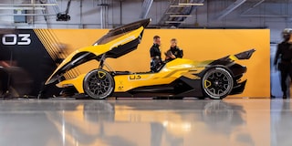 Side View of a Yellow and Black 2026 Corvette CX.R Racing on a Track