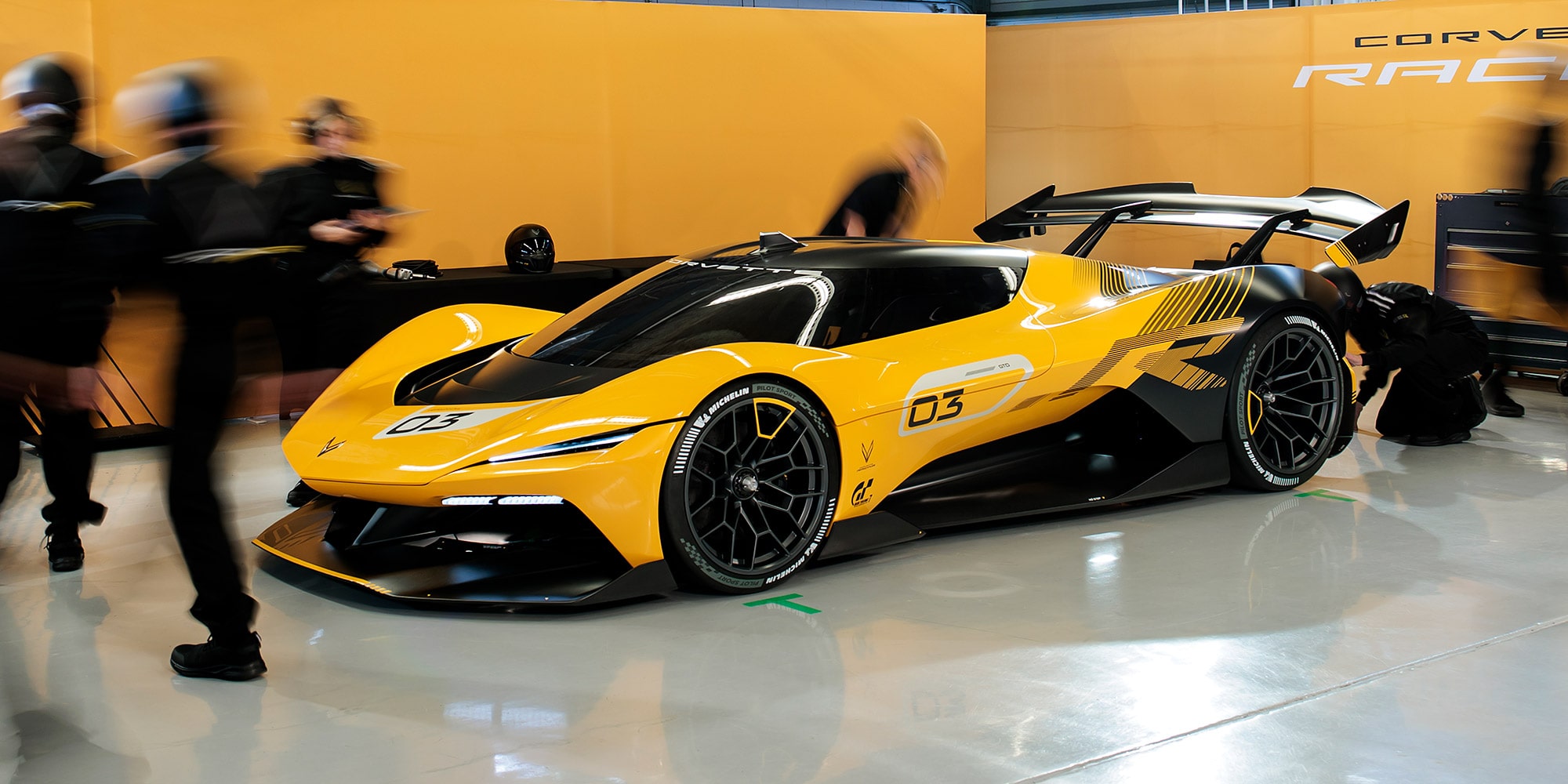 Front driver side view of a 2026 Corvette CX.R surrounded by a pit crew