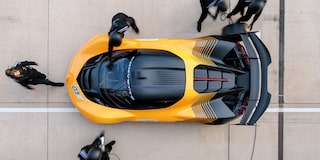 Side View of a Yellow and Black 2026 Corvette CX.R Racing on a Track