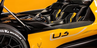 Side View of a Yellow and Black 2026 Corvette CX.R Racing on a Track