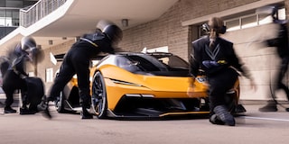 Side View of a Yellow and Black 2026 Corvette CX.R Racing on a Track