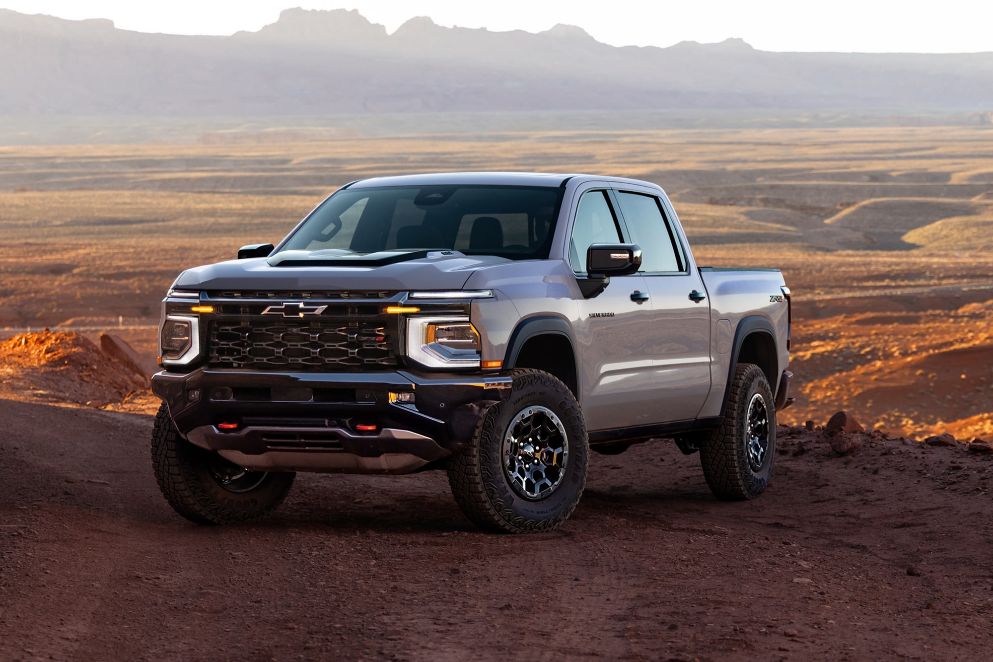 Illustrative: a silver Chevrolet Silverado 1500 ZR2 pickup parked on red desert dirt