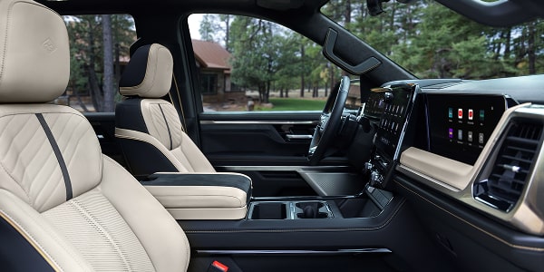 Passenger Seat View of a Man Smiling and Utilizing the Super Cruise Hands-free Technology While Driving a Chevy Silverado