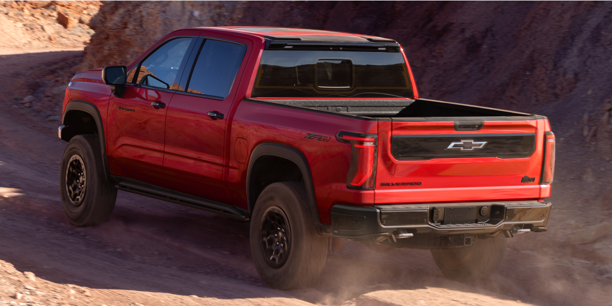 Rear Three-quarters View of a 2027 Chevy Silverado 1500 Off-roading on a Canyon, Desert Road