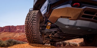 Low Angle Three Quarters View of a 2026 Blue Chevy Colorado on a Desert