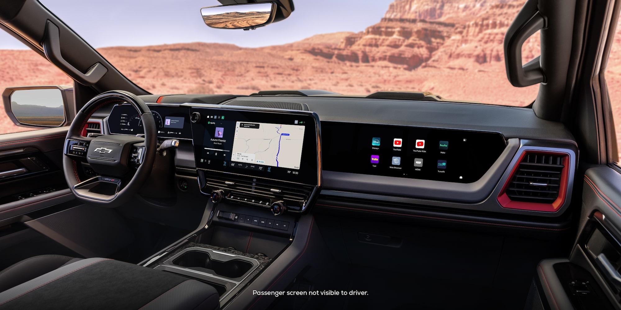 The 2027 Chevrolet Silverado 1500 Front Row Interior and Dashboard While Outlooking a Desert Canyon