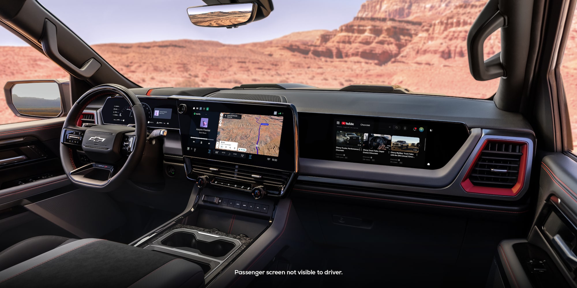 The 2027 Chevrolet Silverado 1500 Front Row Interior and Dashboard While Outlooking a Desert Canyon