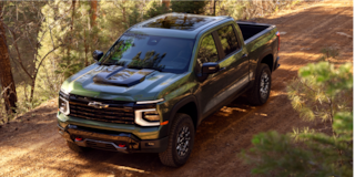 Low Angle Three Quarters View of a 2026 Blue Chevy Colorado on a Desert