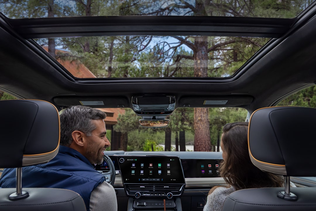 Passenger Seat View of a Man Smiling and Utilizing the Super Cruise Hands-free Technology While Driving a Chevy Silverado
