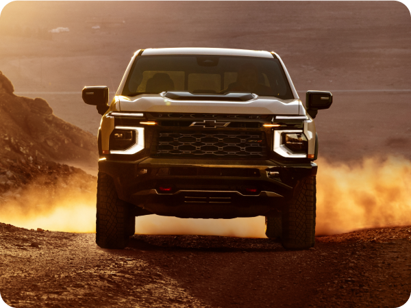 Three-quarters View of a 2027 Chevy Silverado 1500 Parked in an Open Desert with Text Overlay Reading "ZR2"