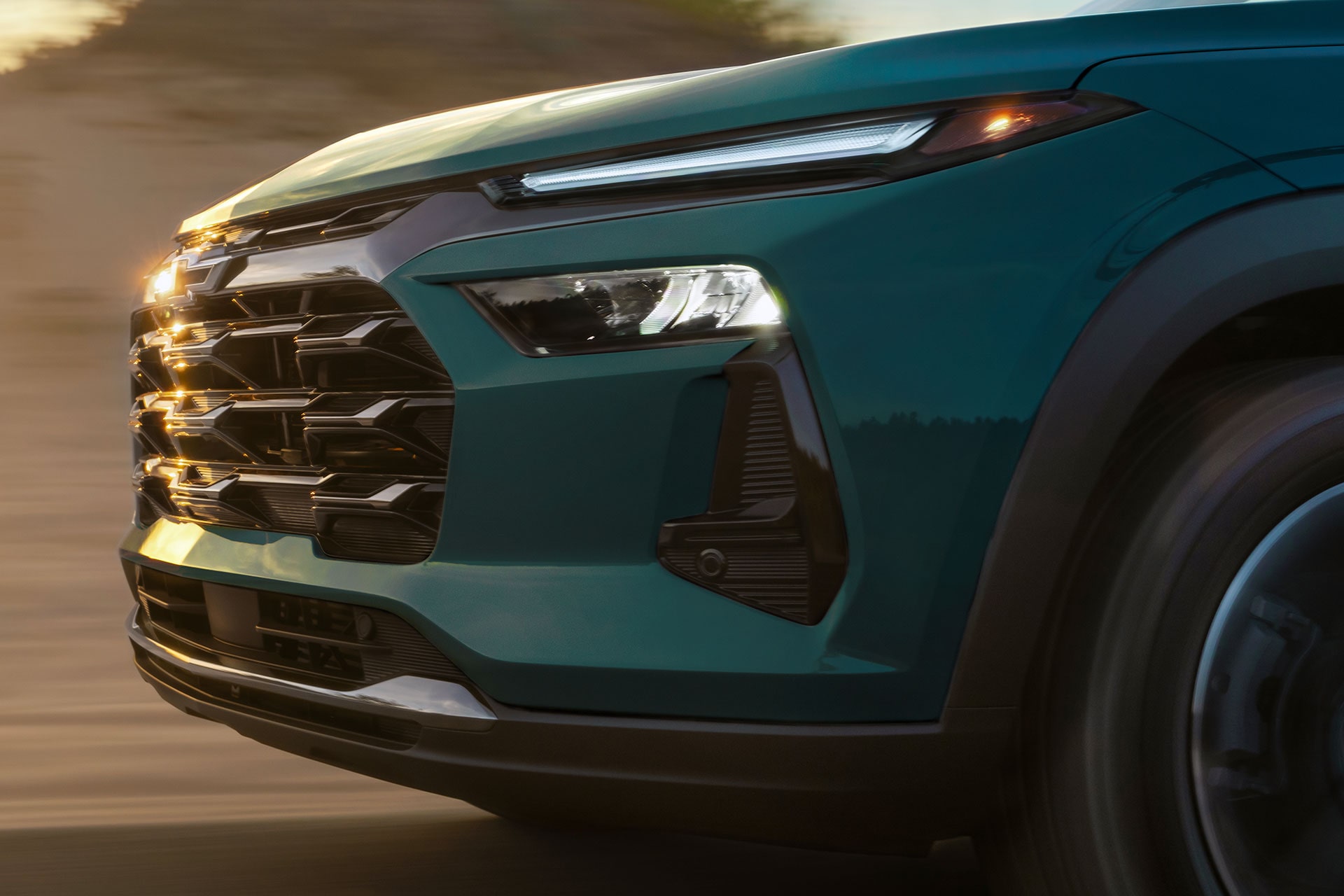A Close-Up of the Side and Headlight of a Chevy Trax Driving.