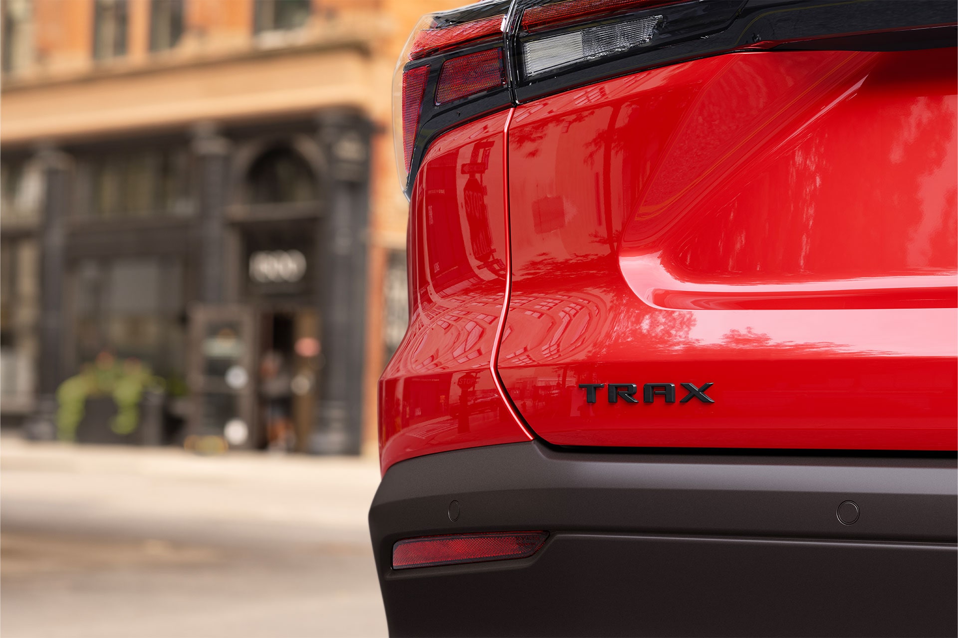 A Close-Up of a Chevy Logo Center Cap Surrounded by Black Alloy Wheel Spokes on a Chevy Trax.