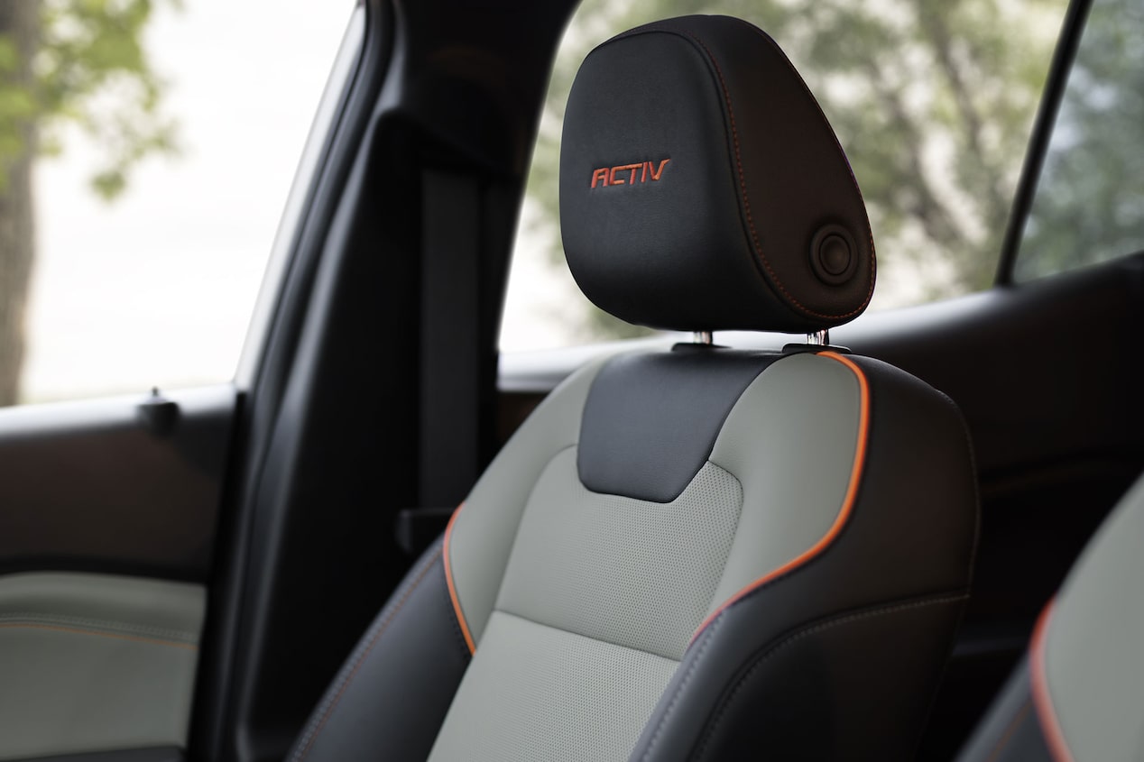 A Close-Up of a Chevy Trax ACTIV Front Seat Featuring Two-Tone Upholstery, Orange Accent Stitching, and an Embroidered ACTIV Headrest Badge.